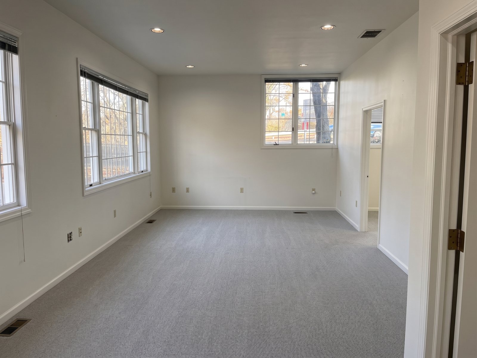 First floor interior, open room with windows on two sides